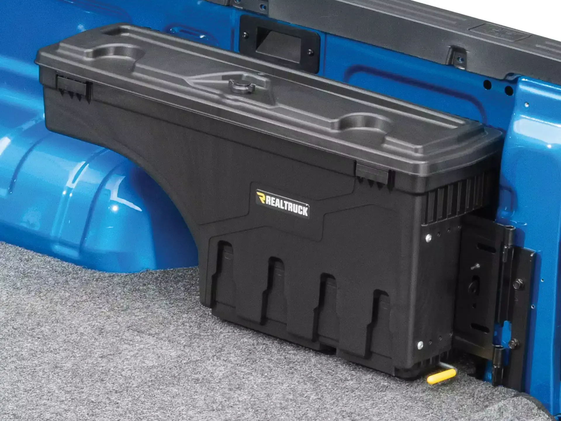 An UnderCover SwingCase swung open beside the wheel well of a blue pickup (UnderCover photo)