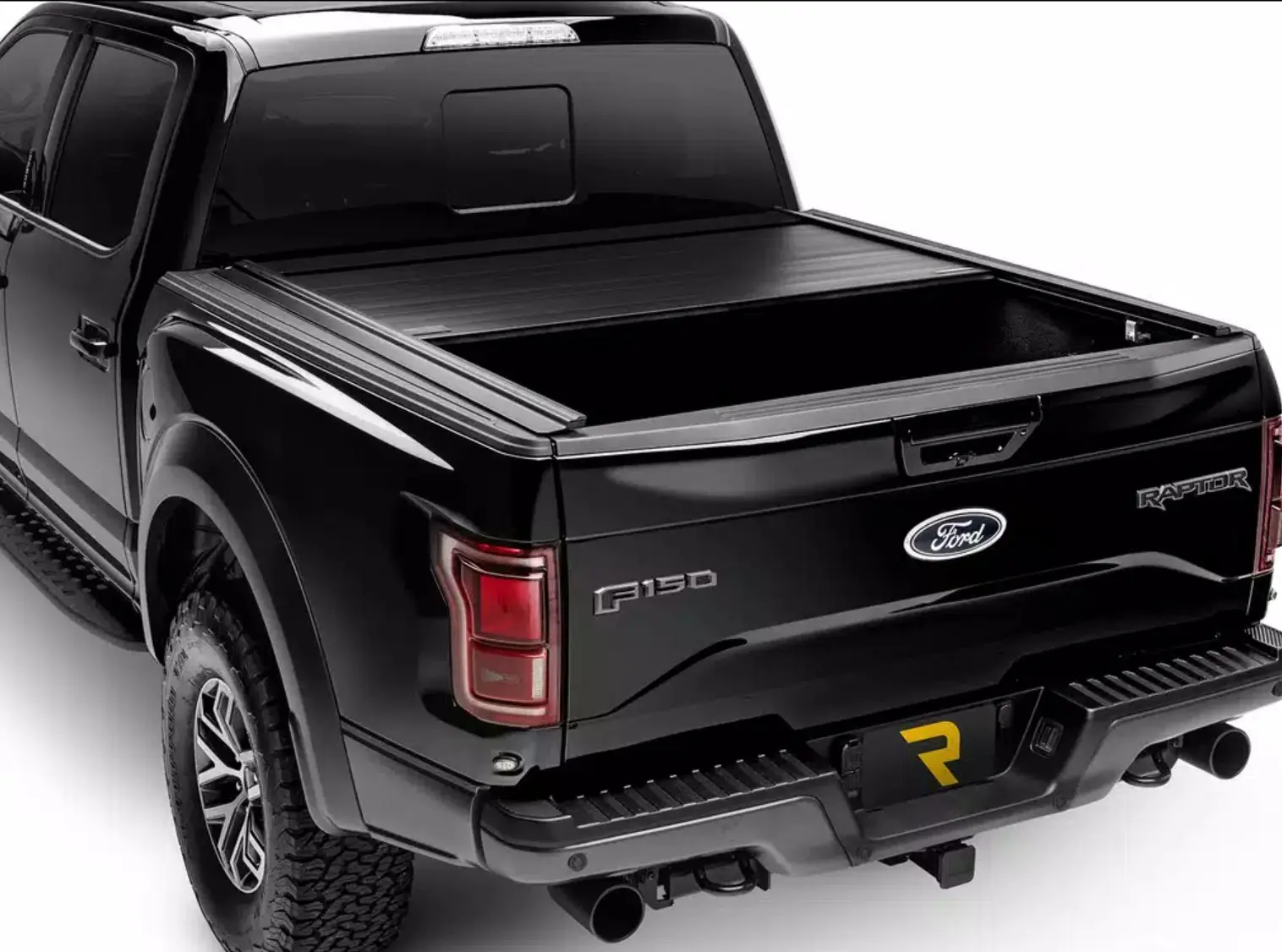 A black Ford F-150 Raptor with a Retrax retractable tonneau cover partly open (Retrax photo)