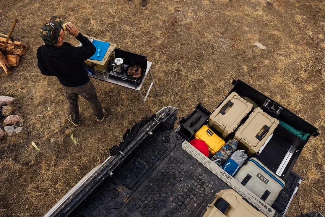 Camp gear laid out of an open DECKED drawer at a campsite (DECKED photo)