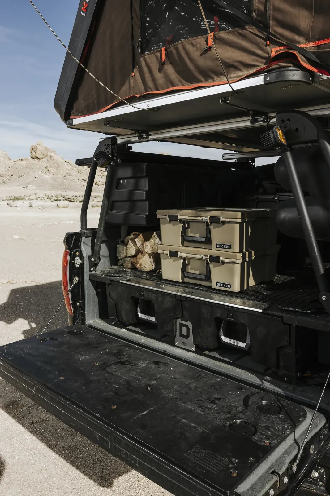 A truck with a DECKED system and a topper open in the desert (DECKED photo)