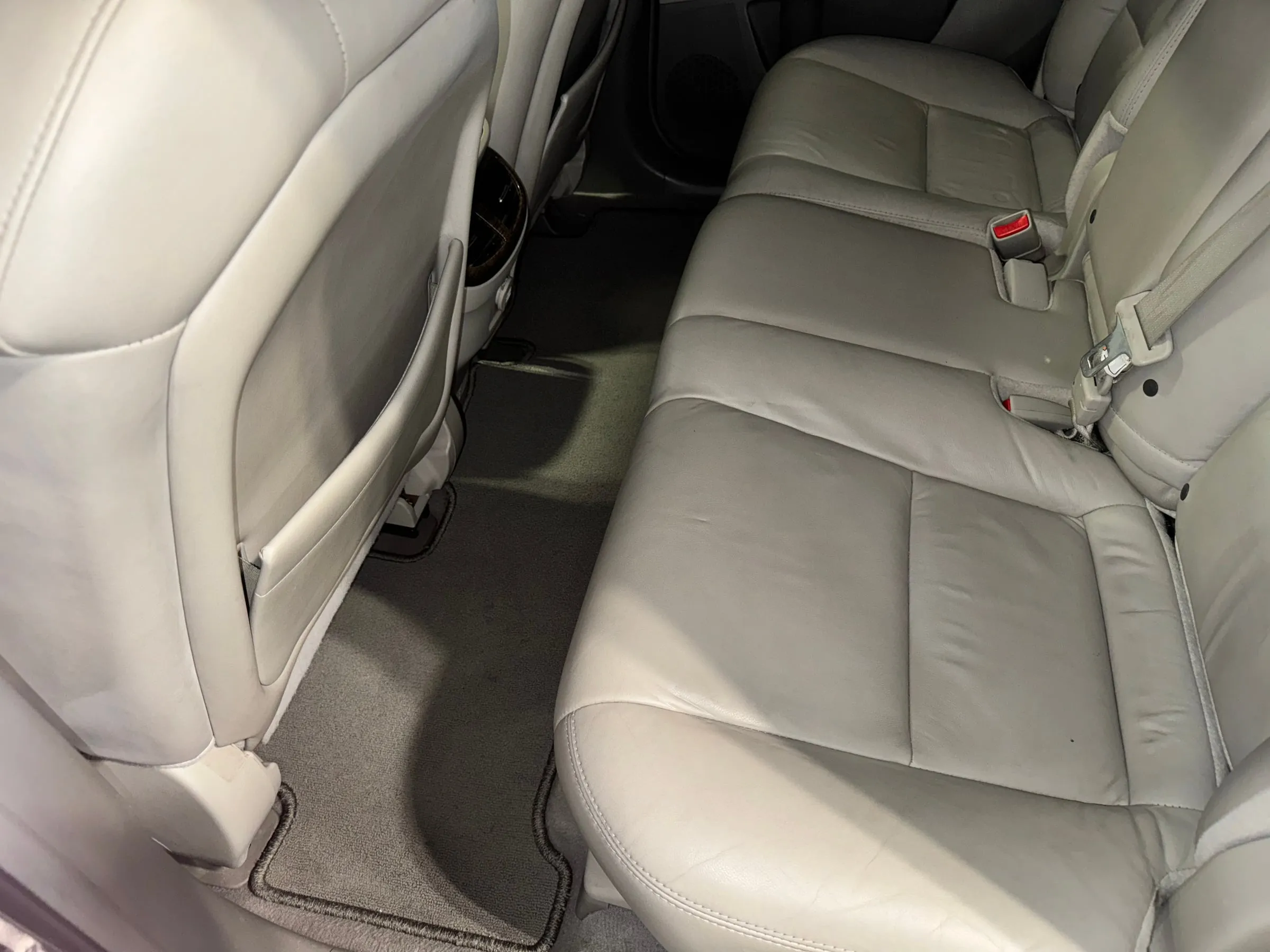 The cream leather rear bench of an SUV after an interior detail