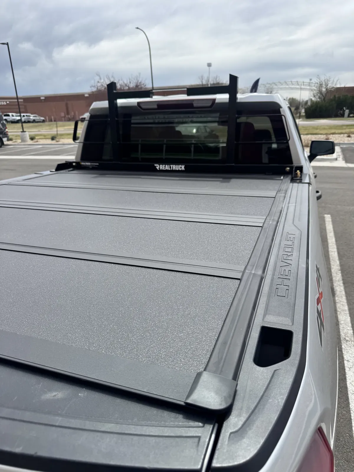 A Chevrolet pickup with a BAKFlip MX4 and a headache rack