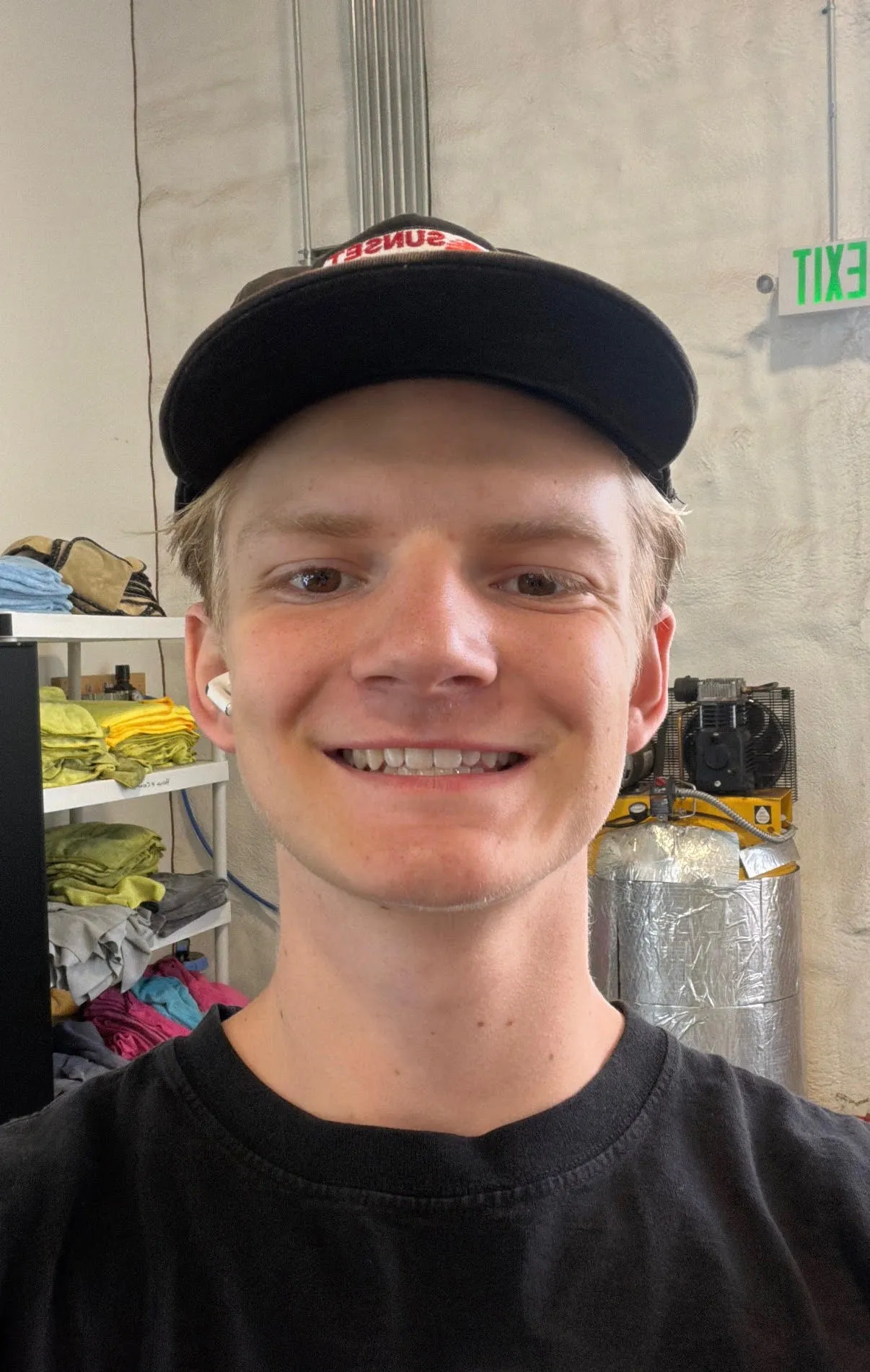 Reese Latimer in a black cap and T-shirt, photographed inside the Ride N' Shine shop