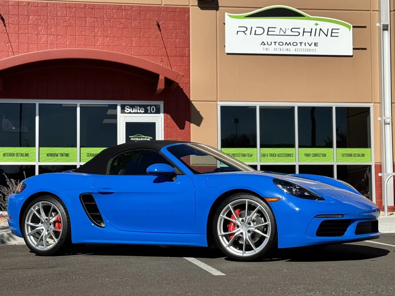 A blue Porsche 718 Boxster parked outside the Ride N' Shine studio in Arvada