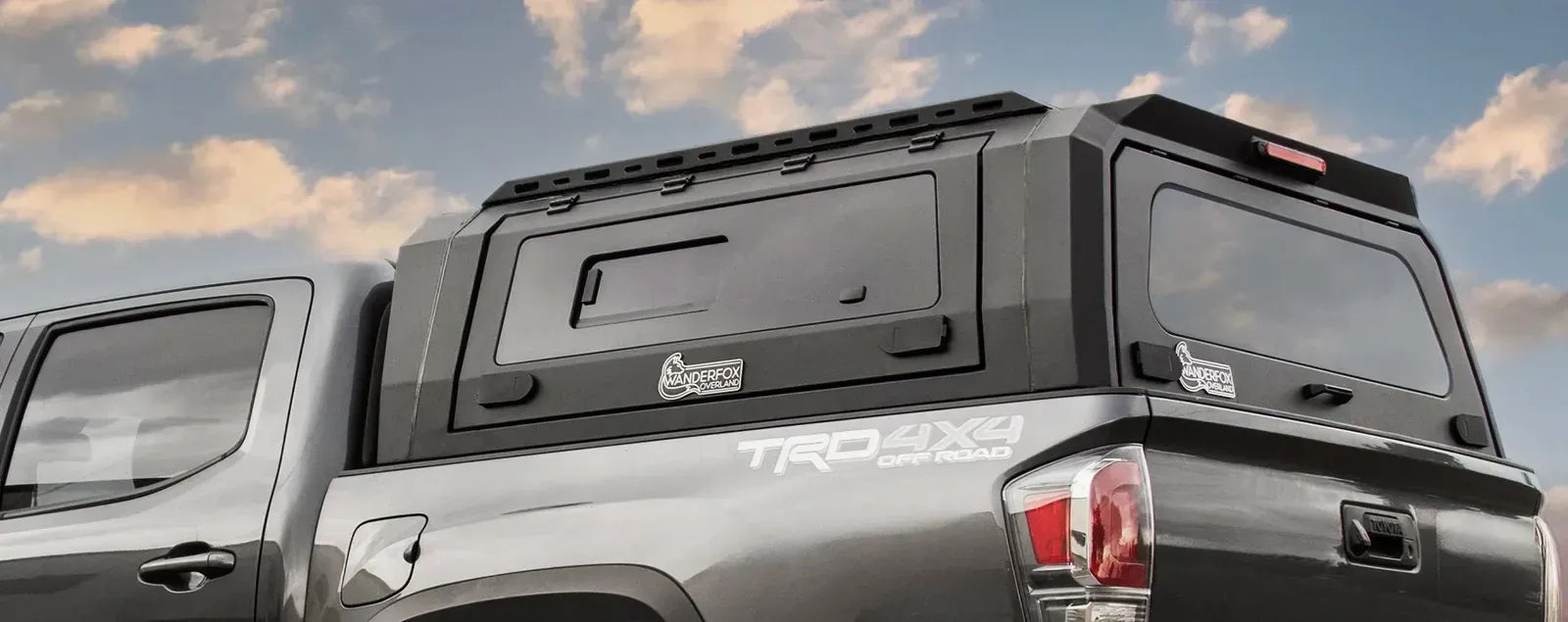 A WanderFox Den topper with its side panels on a gray Tacoma (WanderFox photo)