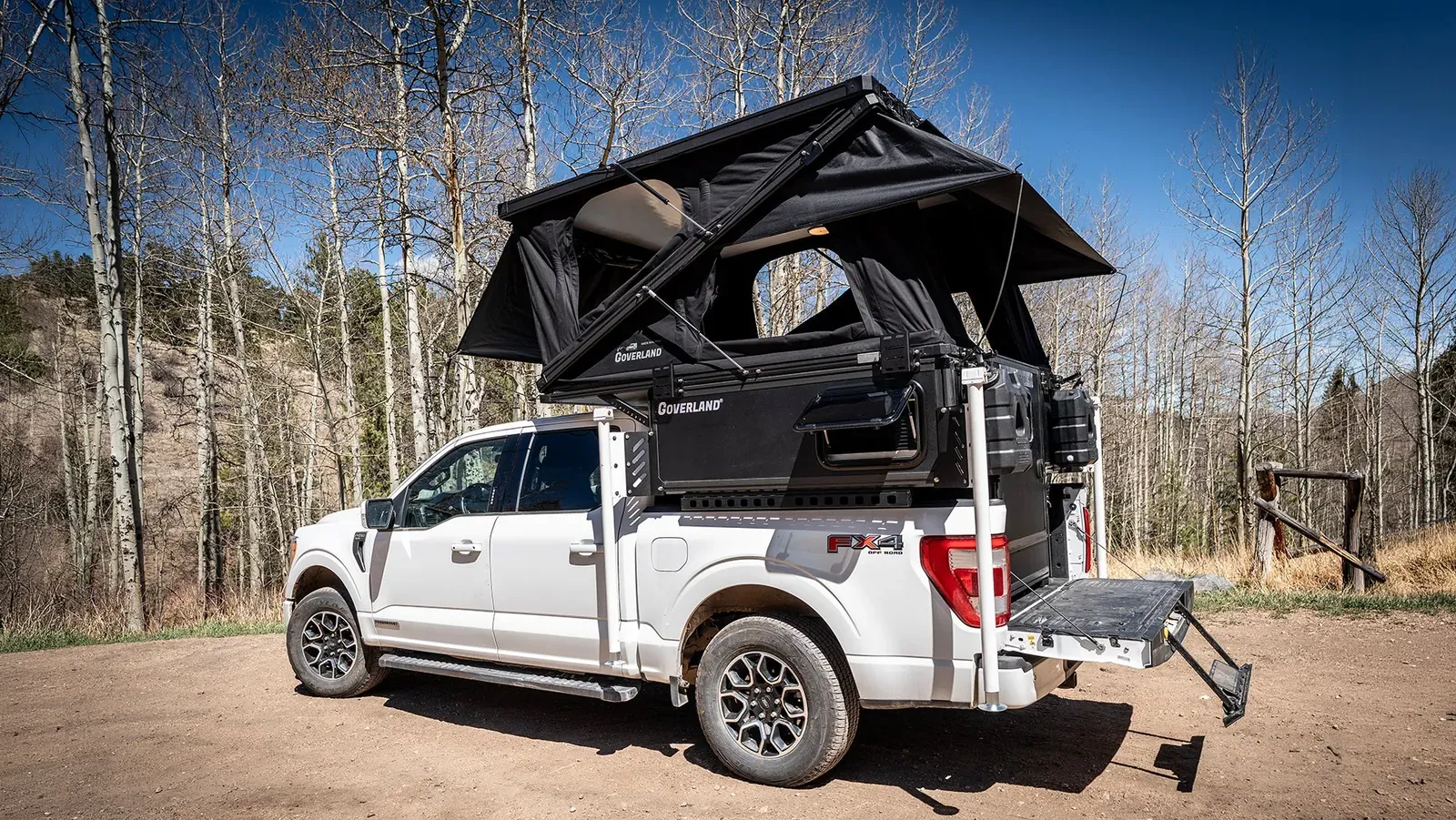A white F-150 with a WanderFox topper, rooftop tent open on top (WanderFox photo)