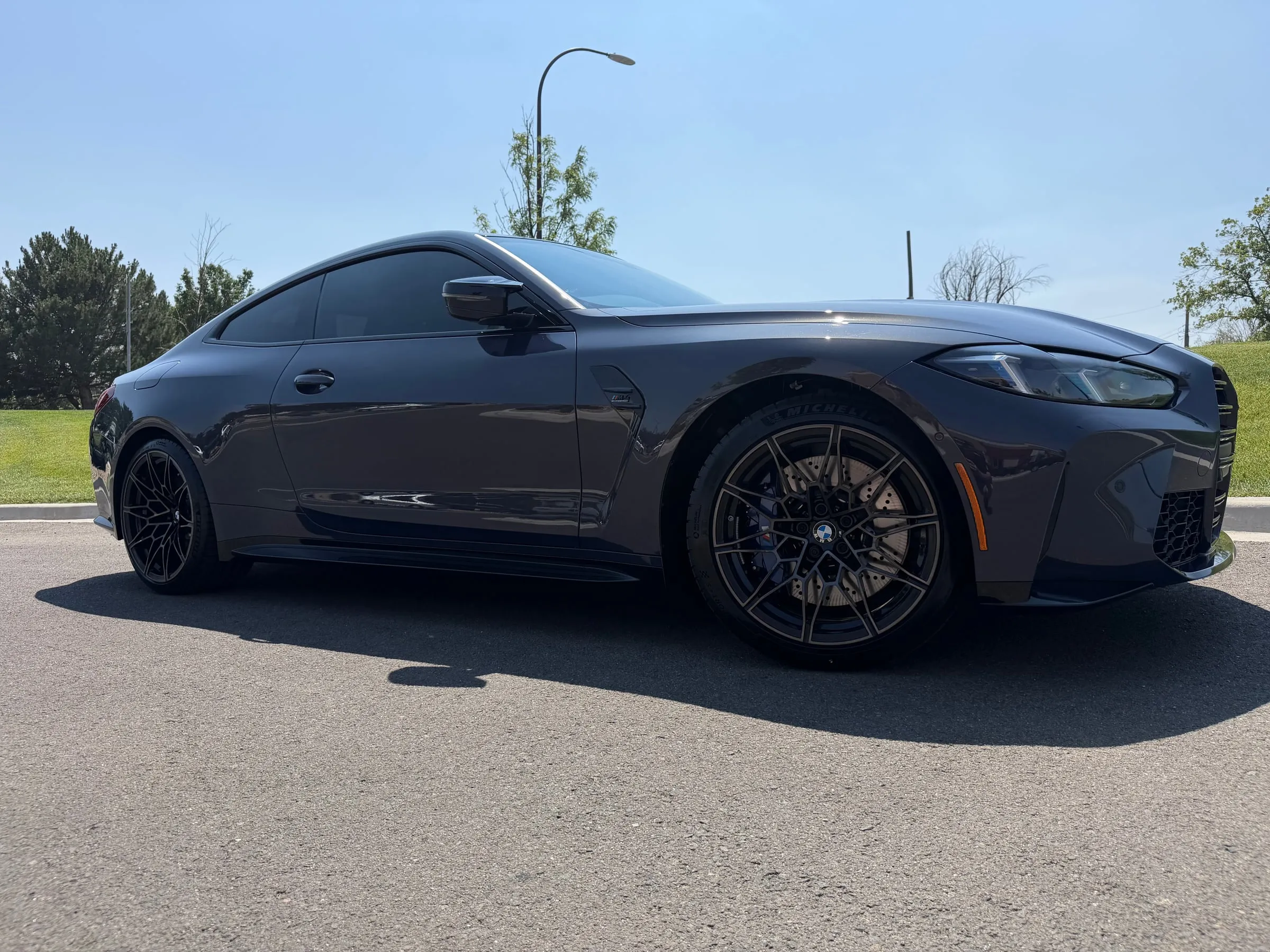 A BMW M3 with freshly installed ceramic window tint parked in the Ride N' Shine bay